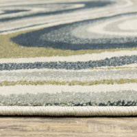 Close-up of Branson Ivory & Blue Abstract Rug, showing power-loomed polypropylene fibers in navy, blue, moss green, and ivory.