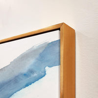 Abstract blue and white giclee canvas art with a textured gold frame, showcasing brush gel finish.