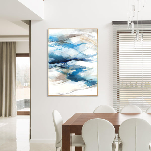 Abstract blue and white giclee canvas painting with brush gel finish in a gold frame, hanging in a modern dining room.