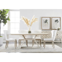 Bridge Dining Table: Reclaimed wood with white wash finish, angular pedestal base, surrounded by white upholstered chairs.