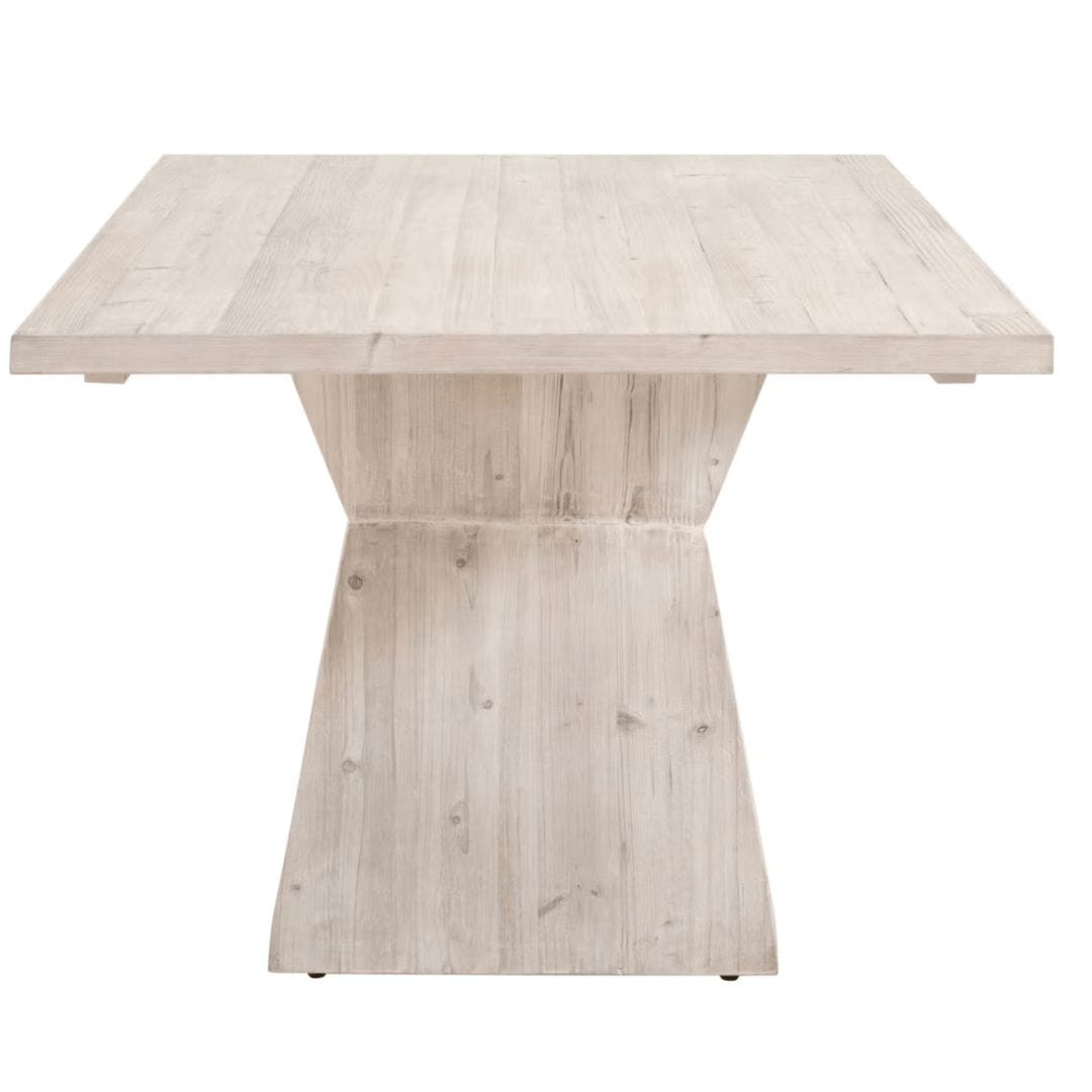 Reclaimed wood dining table with a white wash finish and modern angular pedestal base.