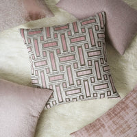 Brix Bella Blush 24x24 throw pillow with a geometric pink and brown pattern on a white shag rug.