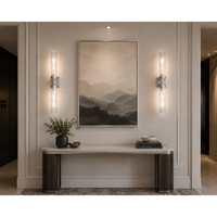 Modern interior with a console table, wall art, and lighting fixtures.