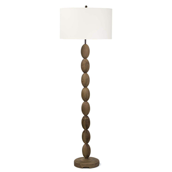 Buoy floor lamp with a birch wood base featuring stacked oval shapes and a white linen drum shade.