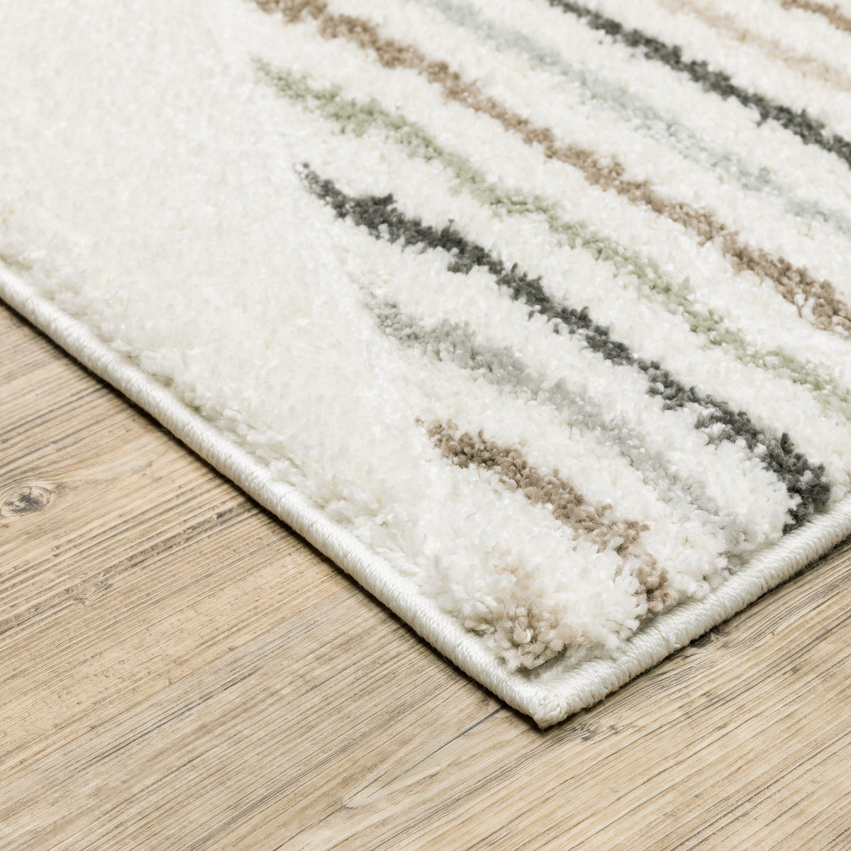 Cambria Beige & Multi Casual Rug, soft polypropylene, power-loomed with carved texture, on wood floor.