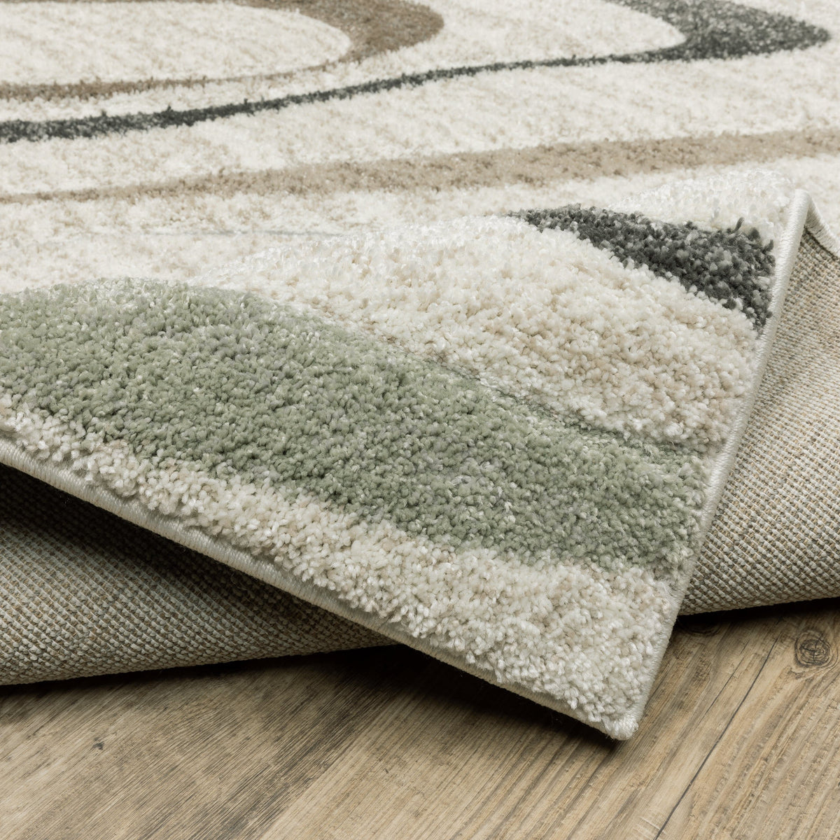 Cambria beige multi-colored contemporary rug with subtle pale blue and mint hues, showing soft polypropylene pile and woven backing.