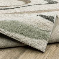 Cambria beige multi-colored contemporary rug with subtle pale blue and mint hues, showing soft polypropylene pile and woven backing.