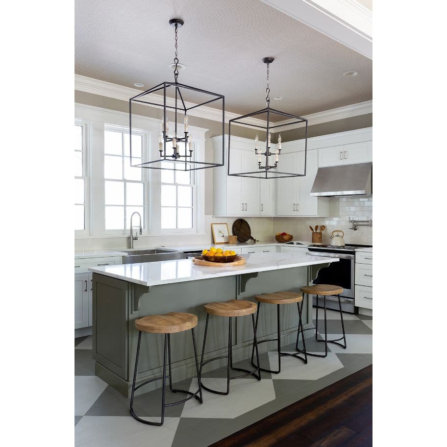 Two large Cape Lantern Blackened Iron chandeliers with geometric frames and candelabra lighting over a kitchen island.