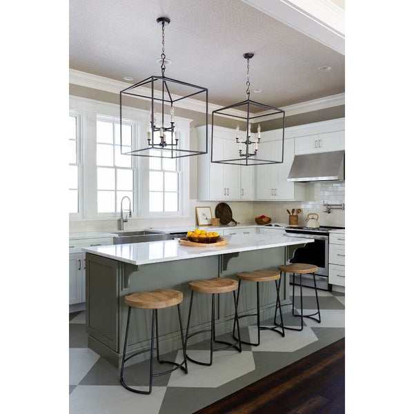 Two large Cape Lantern Blackened Iron chandeliers with geometric frames and candelabra lighting over a kitchen island.