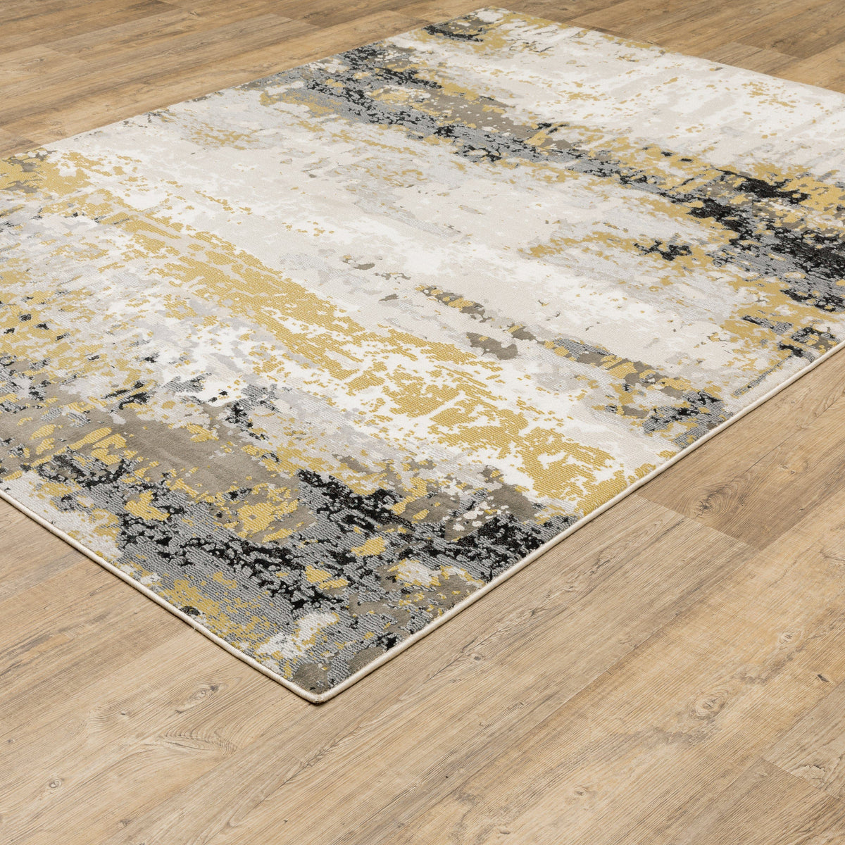 Caravan Beige & Gold Contemporary Rug with abstract design, power-loomed polyester, on a wood floor.
