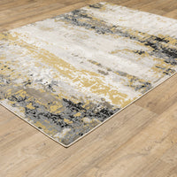 Caravan Beige & Gold Contemporary Rug with abstract design, power-loomed polyester, on a wood floor.