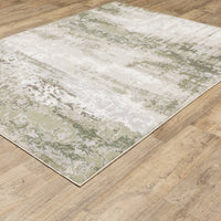 Caravan Beige & Green Contemporary Rug with abstract, textured polyester design on a wood floor.