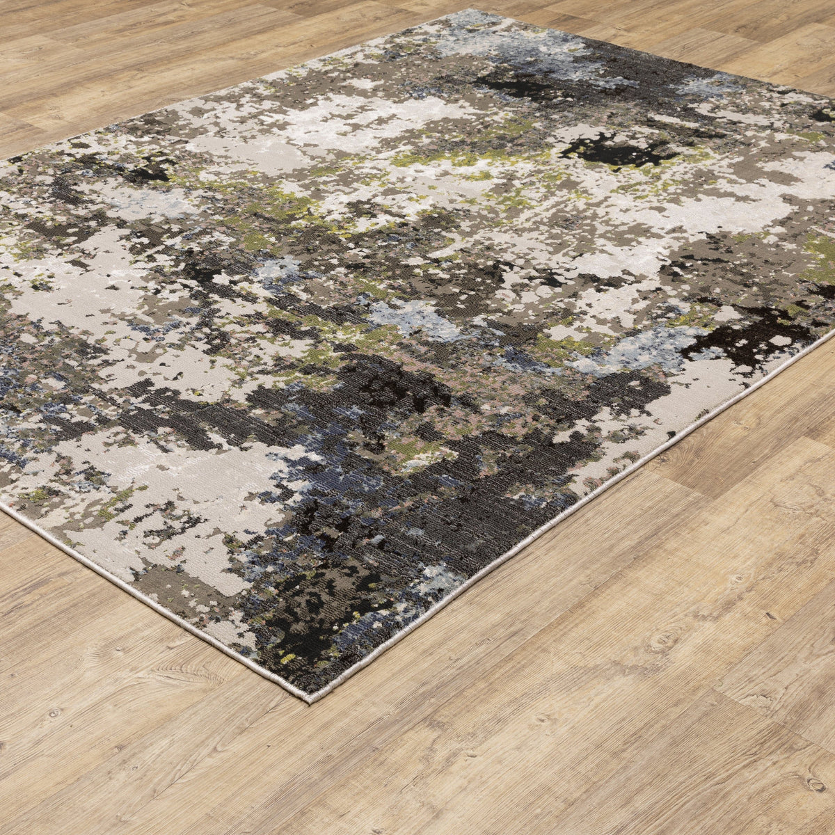 Caravan Grey & Moss Green Contemporary Rug with abstract design on a wooden floor.
