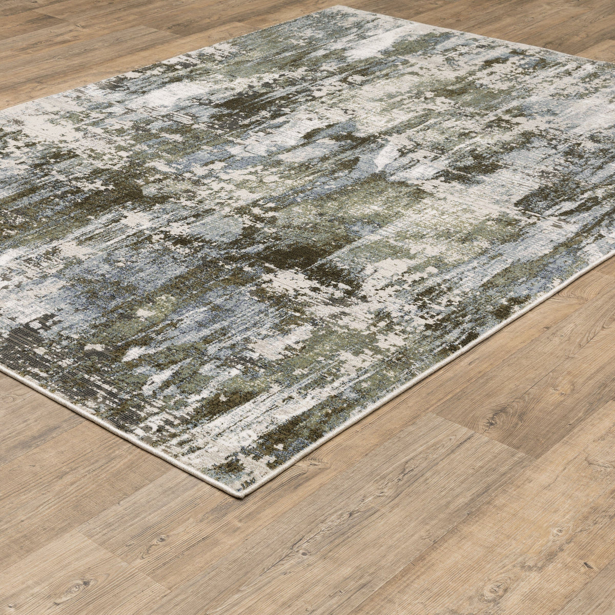 Caravan Moss Green & Blue Contemporary Rug with textured, multi-level surface on a wood floor.
