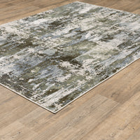 Caravan Moss Green & Blue Contemporary Rug with textured, multi-level surface on a wood floor.