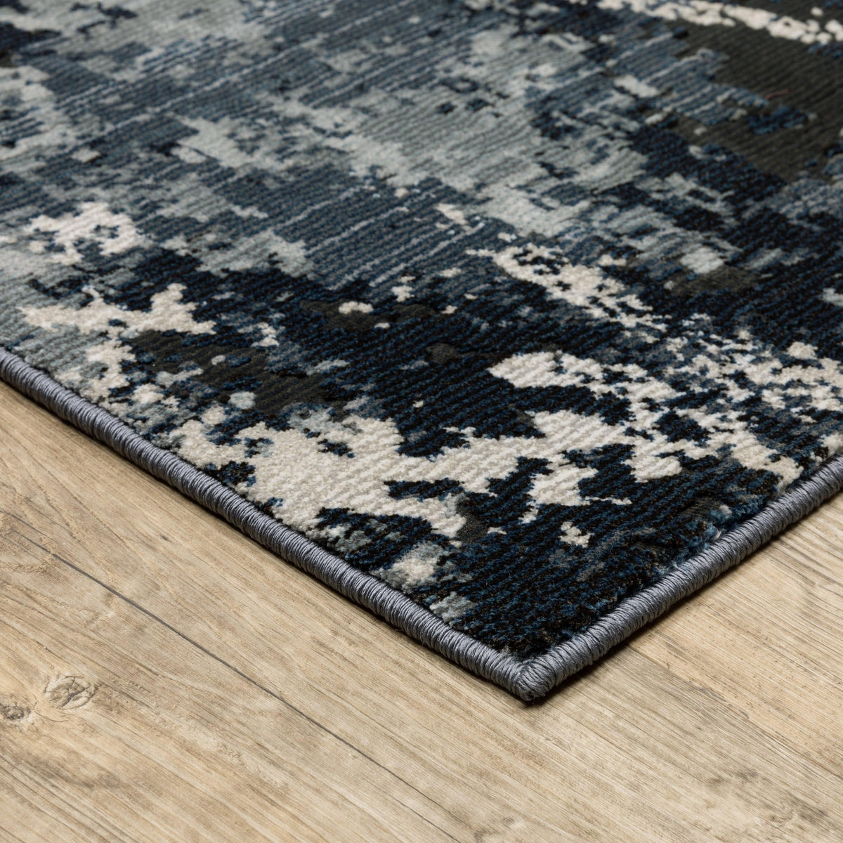 Caravan Multi-Blue Contemporary Rug with textured, multi-level surface in warm and cool tones on wood floor.