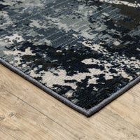 Caravan Multi-Blue Contemporary Rug with textured, multi-level surface in warm and cool tones on wood floor.