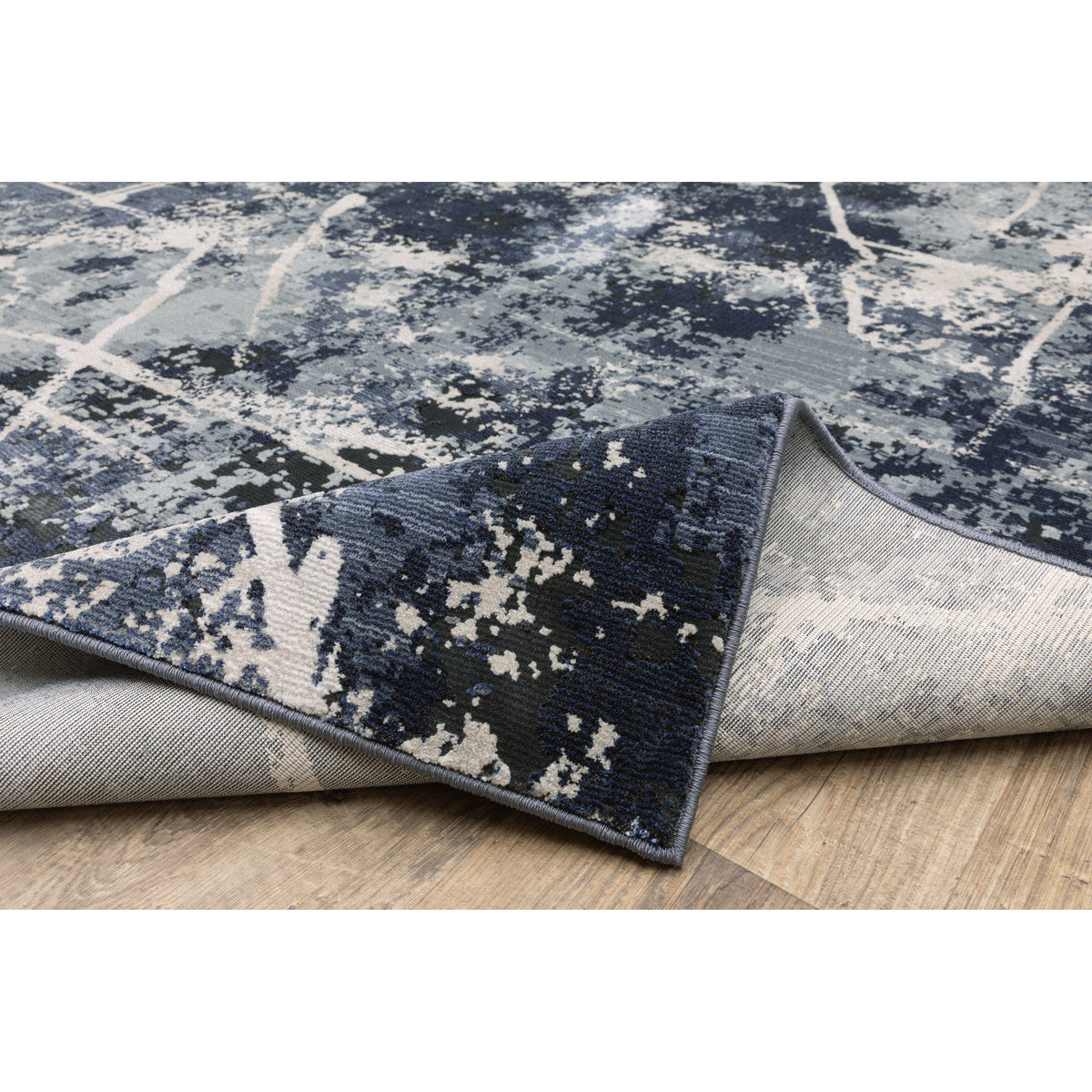Caravan Multi-Blue Contemporary Rug with abstract blue, gray, and white pattern, showing textured polyester surface and woven backing.