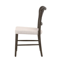 Carly Matte Brown Cane Dining Chair with light fabric seat, side view.