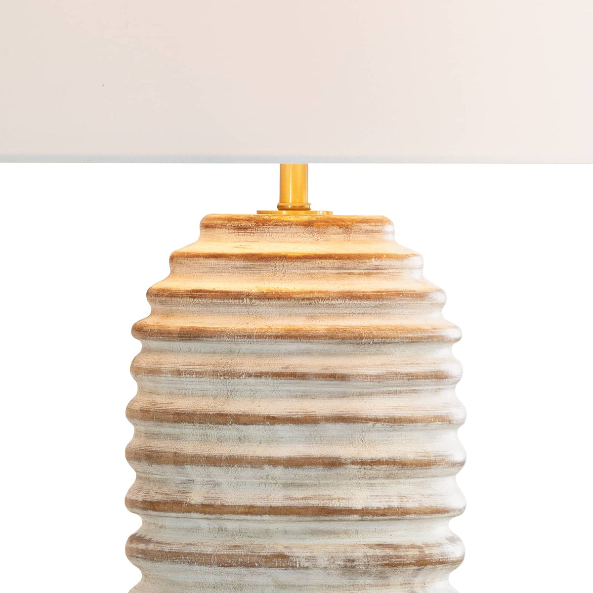 Carmel Wood Table Lamp with a distressed, white-washed body, carved ridges, and a large white drum shade.