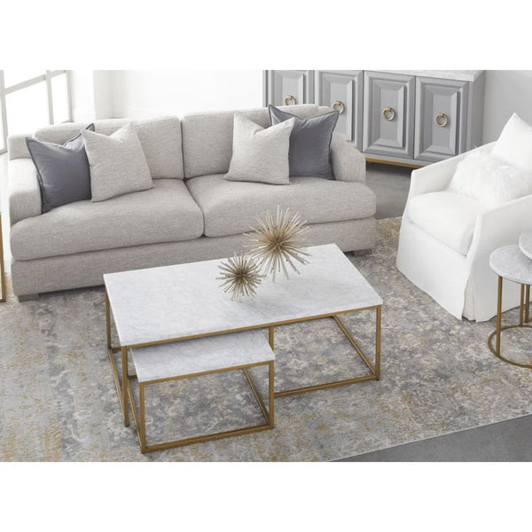 Carrera Nesting Coffee Table with white marble veneer tops and brushed gold steel bases, in a living room.