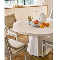 White ceramic Caspian vase with unique ridges on a light wood dining table.