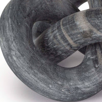 Abstract Cassius marble sculpture, hand-carved, dark gray with natural veining, flowing singular form.