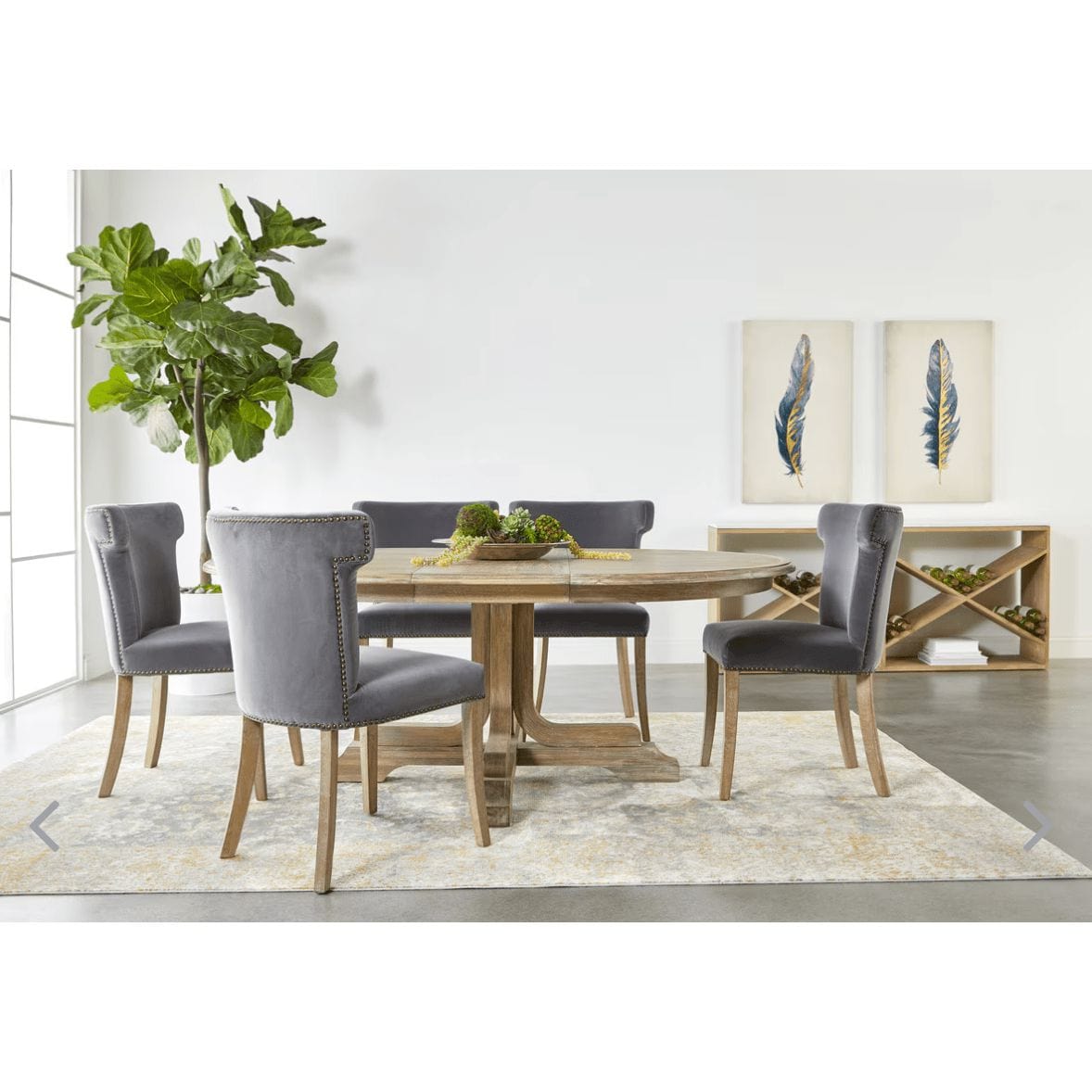 Dark dove velvet dining chairs with wingback design around a rustic wood table.