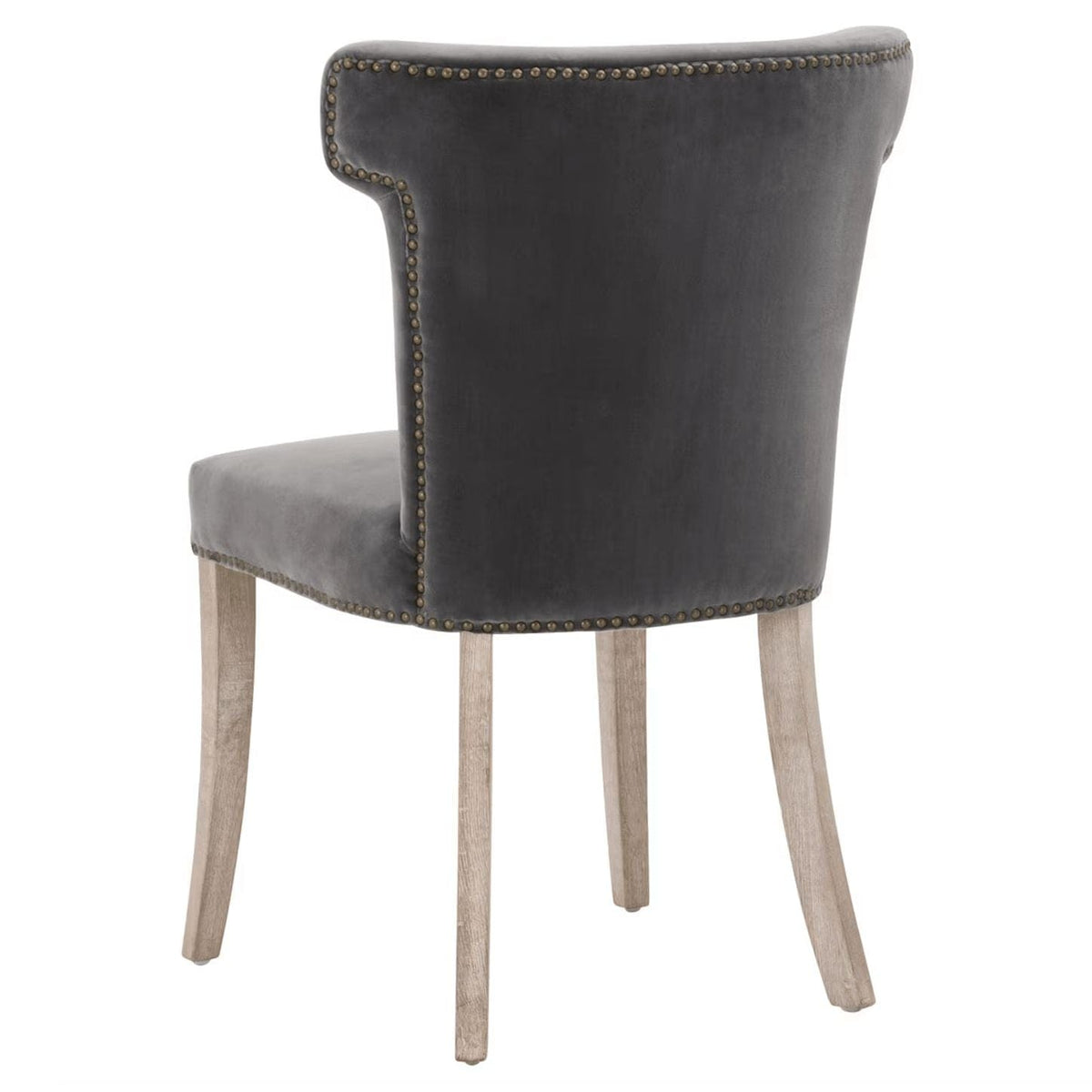Dark dove gray velvet dining chair with sculpted wingback design, brass nailhead trim, and light wood legs.