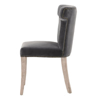 Celina Dark Dove velvet dining chair with sculpted wingback design and nailhead trim.