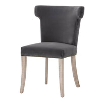 Dark dove velvet dining chair with sculpted wingback, nailhead trim, and light wood legs.