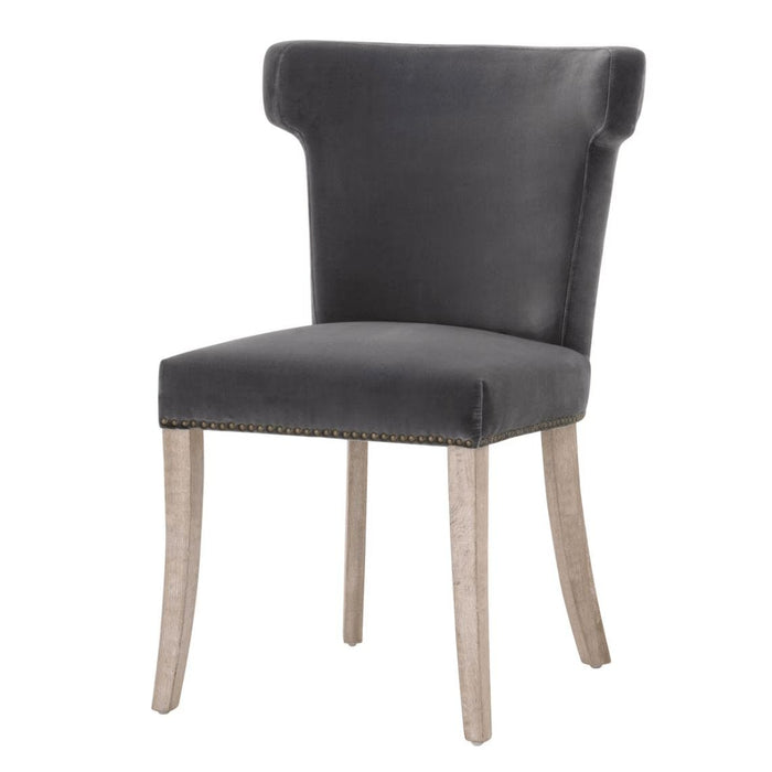 Dark dove velvet dining chair with sculpted wingback, nailhead trim, and light wood legs.