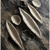 Whitewashed Ardu wood decorative bowls and trays with rustic, natural designs on a dark marble surface.