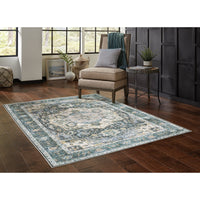 Charleston Blue & Ivory washable rug with distressed traditional design on a dark wood floor.