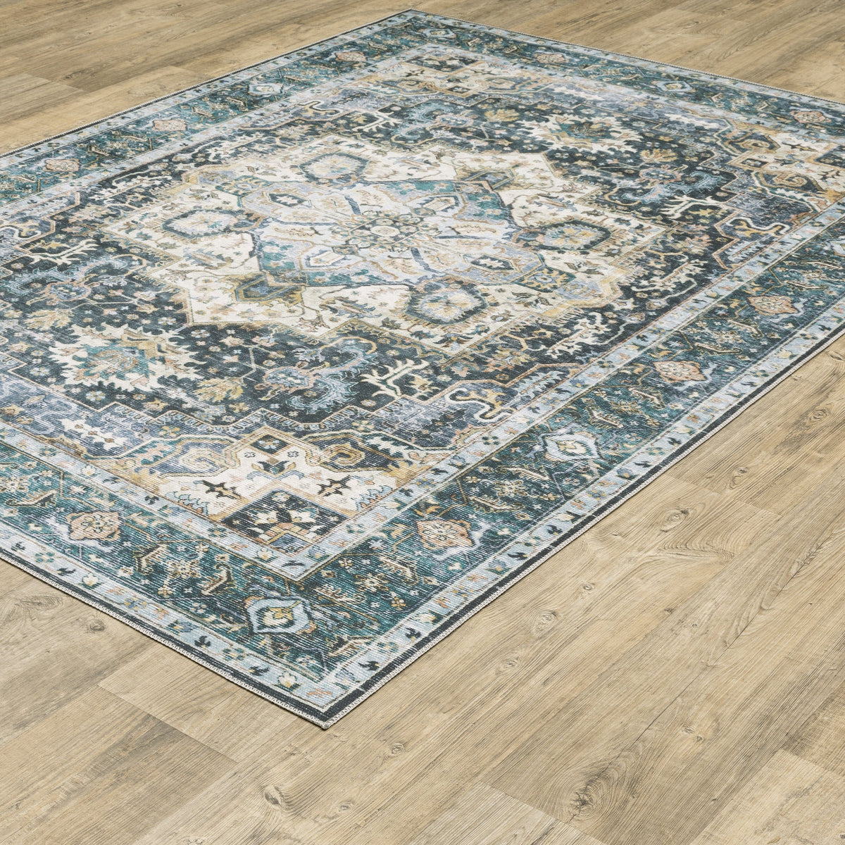 Charleston Blue & Ivory washable polyester rug with distressed traditional design on wood floor.