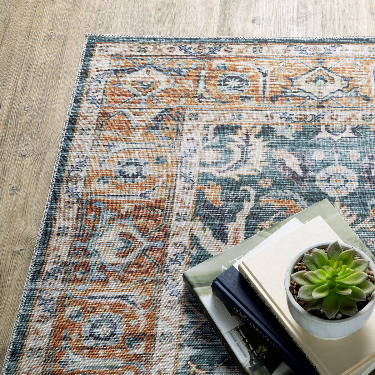 Charleston Blue & Rust washable rug with distressed traditional patterns, blanket stitch finish, and non-slip backing.