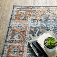 Charleston Blue & Rust washable rug with distressed traditional patterns, blanket stitch finish, and non-slip backing.