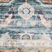 Close-up of a Charleston Blue & Rust washable rug, showing distressed traditional patterns in teal, cream, and orange.