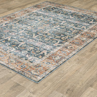 Charleston Blue & Rust washable polyester rug with distressed traditional patterns and a blanket stitch finish on a wood floor.