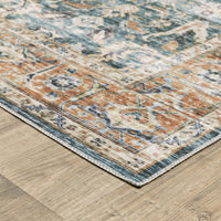 Charleston Blue & Rust washable polyester rug with distressed traditional patterns and blanket stitch finish on wood floor.