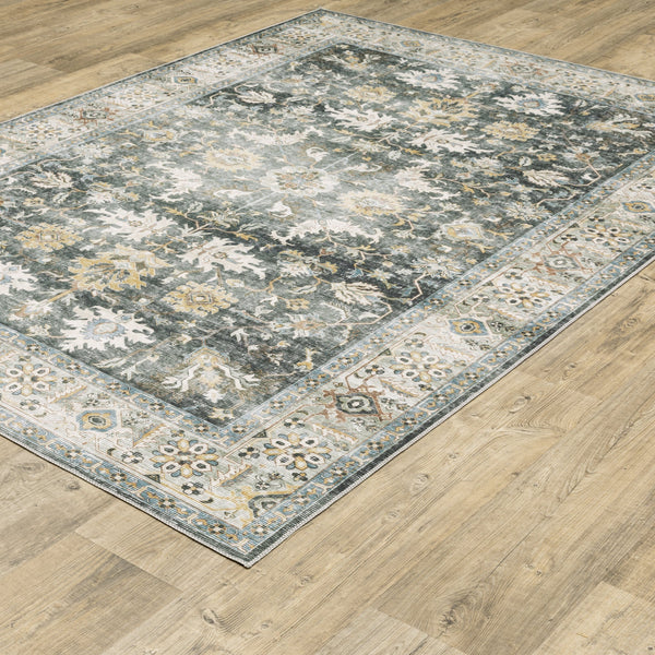 Charleston Charcoal & Gold Washable Rug with distressed traditional patterns on a wood floor.