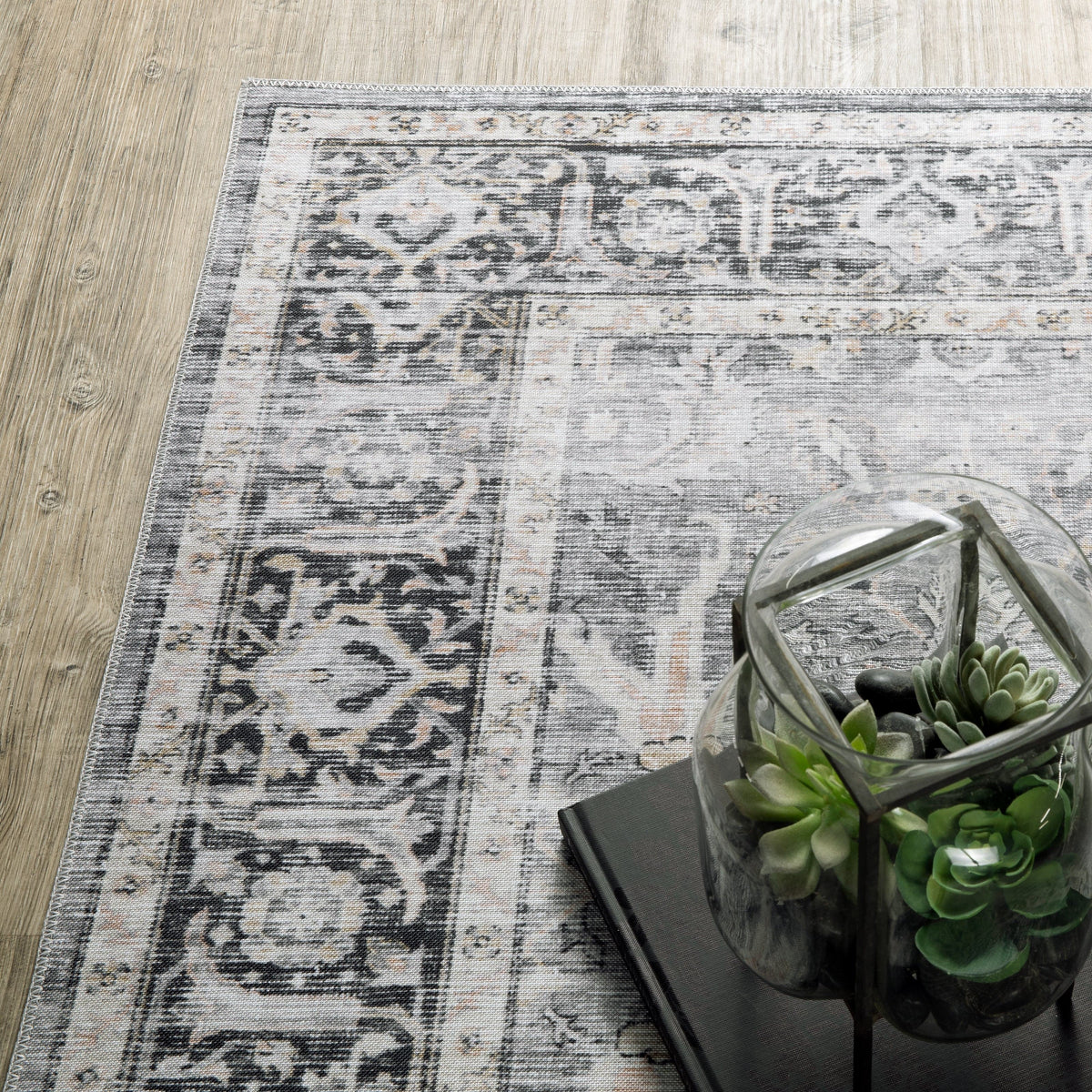 Charleston Charcoal & Grey Washable Rug with intricate medallion design on light wood floor.