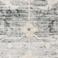 Close-up of a Charleston Charcoal & Grey Washable Rug with a subtle distressed pattern and light yellow accents.