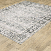 Charleston Charcoal & Grey Washable Rug with an ornate, machine-printed design on a light wood floor.