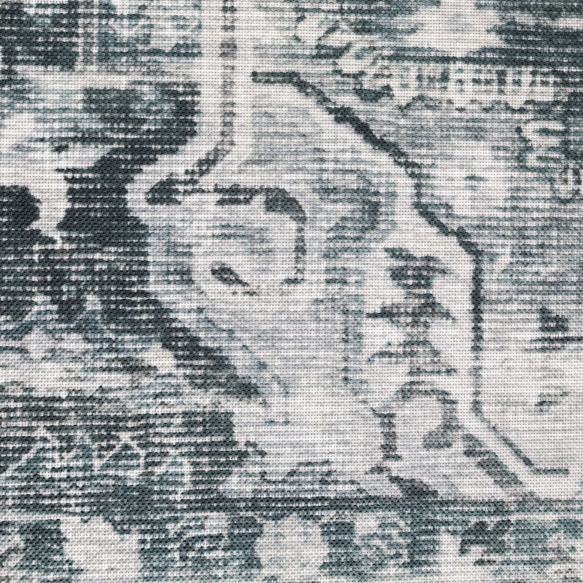 Close-up of a Charleston Charcoal & Ivory Washable Rug, showing distressed traditional patterns on polyester.