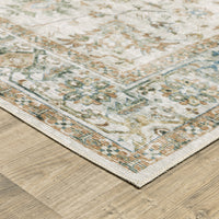Charleston Ivory & Multi-Color Washable Rug with distressed traditional patterns on a wood floor.