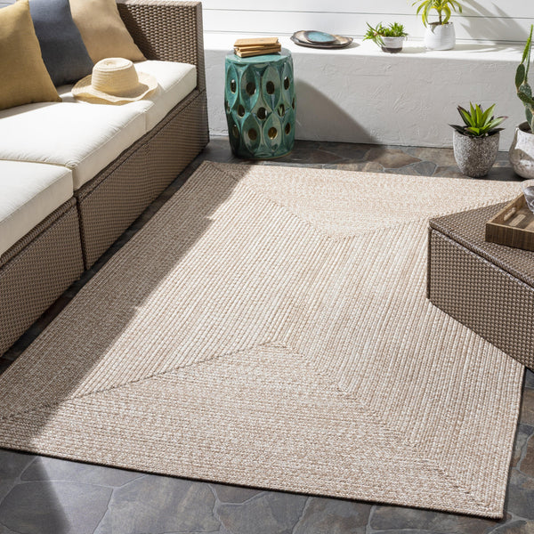 Chesapeake Bay Camel & Cream outdoor rug, braided polypropylene, no pile, in a patio setting.