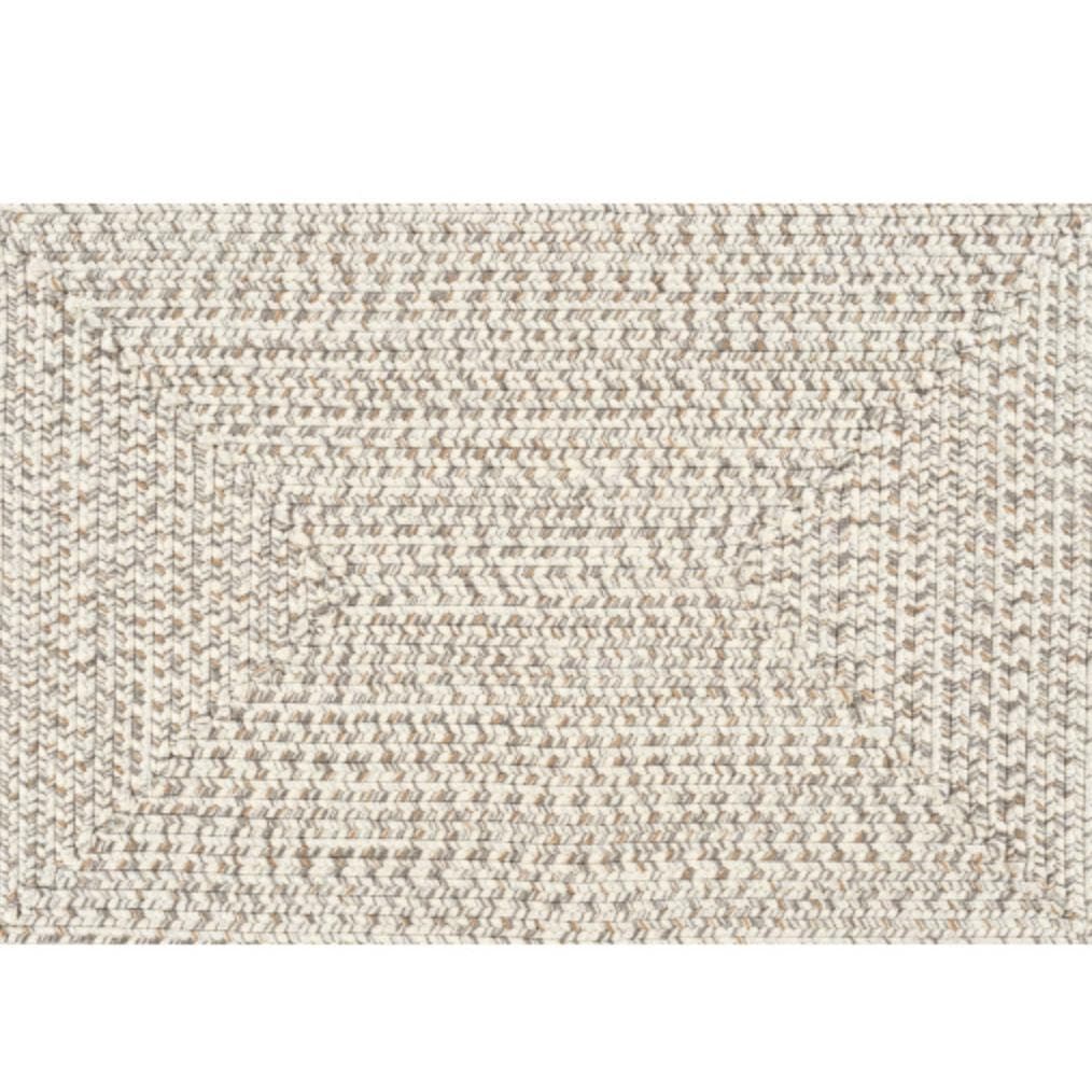 Cream, charcoal, and brown braided polypropylene outdoor rug with no pile.