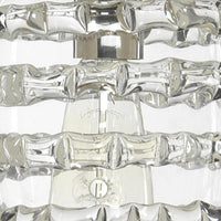 Clear glass round ribbon pendant light with nickel hardware and visible bulb.