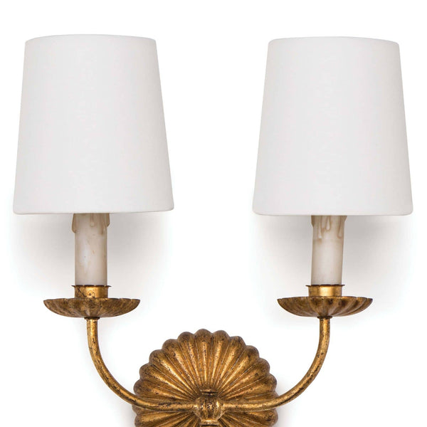 Clove Double Sconce with antique gold leaf ribbed backplate, two antique-inspired candles, and crisp white linen shades.